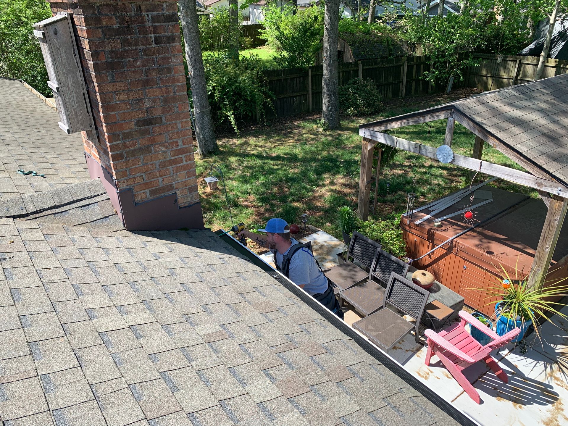 Virginia Beach Gutter Replacement In Process - Gutter Installation Expert Using Drill to Install Gutters Photo